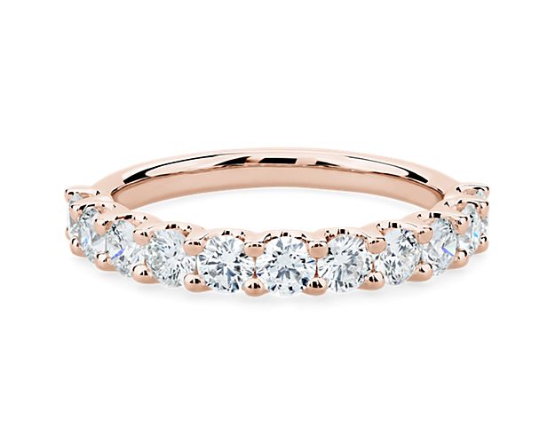 A classic beauty, this gorgeous 14k rose gold diamond ring showcases a sparkling row of shared-prong set diamonds.