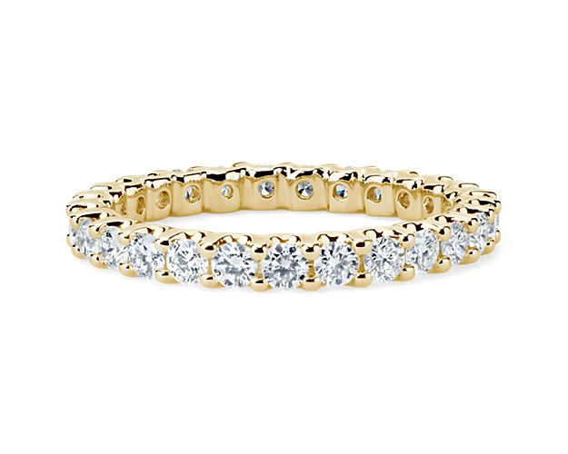 Brilliant in every way, this diamond eternity ring features round diamonds in a shared-prong and low-profile design of 14k yellow gold.
