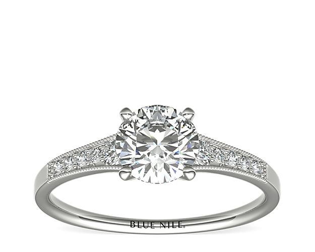 Ideal for any center diamond of your choice, this platinum engagement ring showcases a diamond accent along the shank and milgrain detailing.