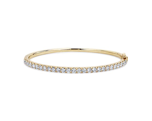Add gorgeous gleam to your wrist with this round bangle bracelet crafted from warmly lustrous 14k yellow gold. Brilliant lab-grown diamonds encircle the bracelet, adding sparkling luxury.