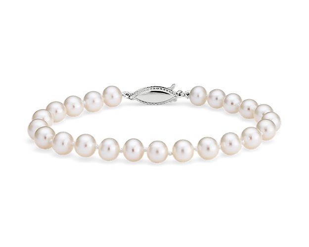 Classically luminous, this Freshwater cultured pearl bracelet features nearly-round white pearls strung on a hand-knotted 8" silk blend cord. A polished 14k white gold safety clasp secures the look.