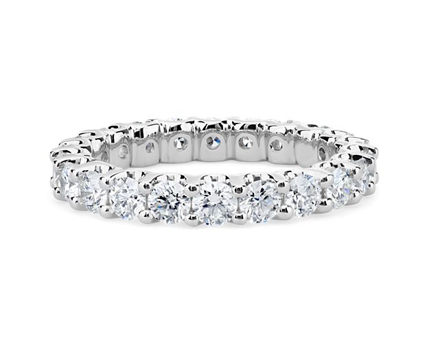 Elegant and brilliant, this diamond eternity ring features round diamonds set in a shared-prong and low-profile design of enduring platinum.