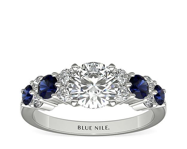 Intricate in design, this sapphire and diamond engagement ring showcases eight diamonds alternating with brilliant round sapphires in this enduring platinum ring that will complement any center stone of your choice.