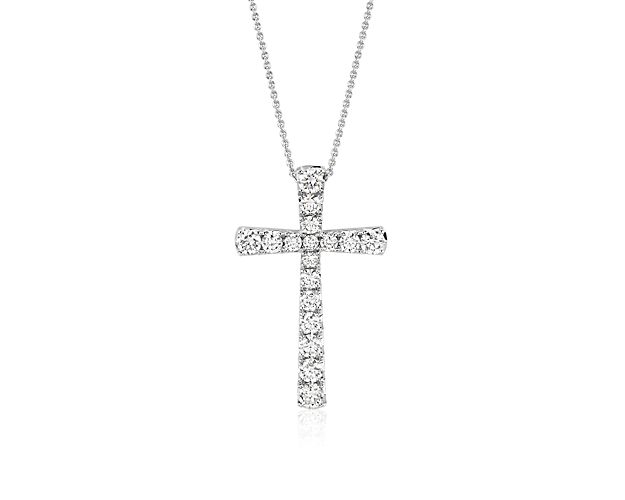 Seventeen brilliant pavé-set round diamonds make up this beautiful cross pendant crafted in 14k white gold.