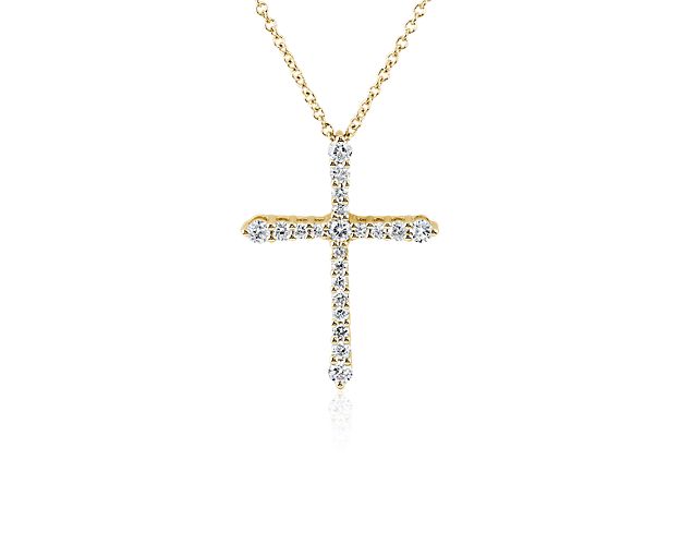 Let your faith shine when you wear this stunning tapered cross pendant set with stunning diamonds for breathtaking sparkle. The brilliance of the stones is beautifully matched with the gleam of the 14k yellow gold design.