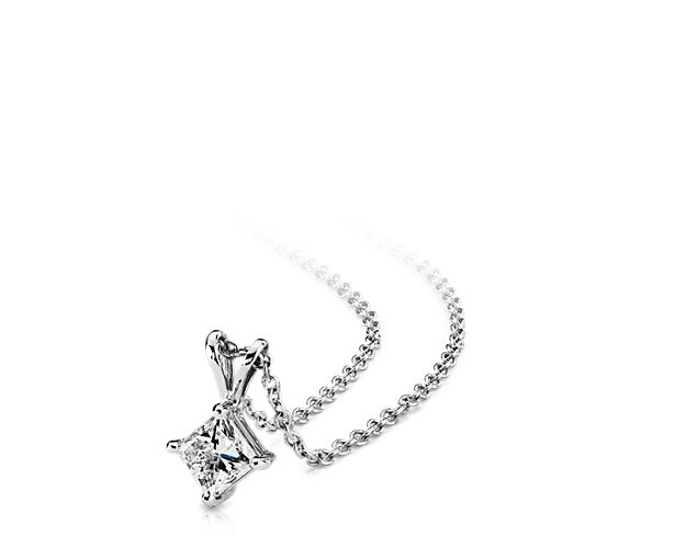 A near-colorless princess cut diamond is secured at the corners by 18k white gold prongs. An 18k white gold bail suspends the pendant from an 18k white gold cable-link chain. 1 carat total diamond weight. Accompanied by either a GIA or GCAL diamond grading report.