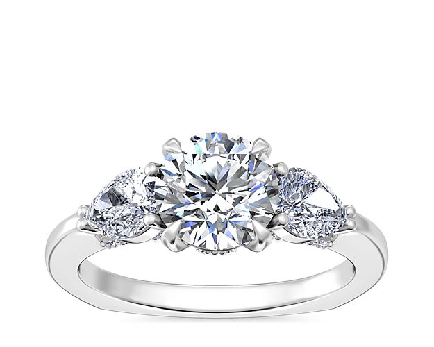 Celebrate the past, present and future with a sparkling pear three-stone engagement ring from our exclusive new Bella Vaughan collection. Crafted with a Euro-shank silhouette tailored for comfort and beauty, this style offers many customizable options with your choice of sidestones in 0.4 or 0.63 carat weights with a round, oval, or cushion-shaped center stone, and your selection of premium precious metal.