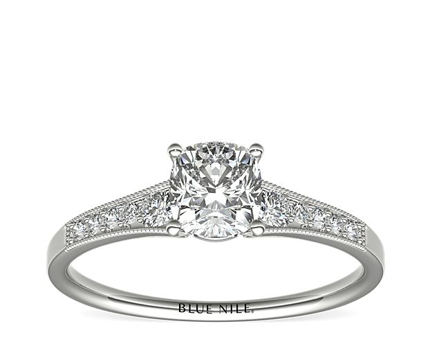 Ideal for any center diamond of your choice, this platinum engagement ring showcases a diamond accent along the shank and milgrain detailing.
