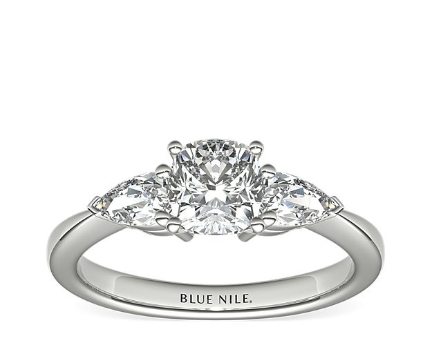 Exceptionally crafted, this diamond engagement ring showcases two beautifully matched pear-shaped diamonds prong-set in platinum to frame your center diamond. Diamonds equal 1/2 carat total weight.