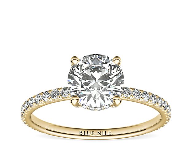Beautifully crafted, this Blue Nile Studio 18k yellow gold engagement ring features french pavé-set diamonds encompassing the center diamond of your choice.
