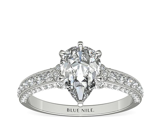 With a touch of elegance, this diamond engagement ring features pavé-set diamond rolling across the shank of the ring, all set in enduring platinum.