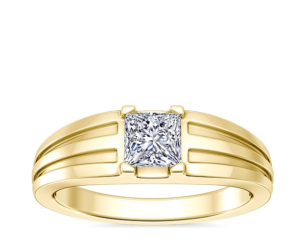 Love shines brilliantly from this engagement ring featuring an elegant center setting that  supports princess (prince), emerald-cut, and radiant-cut diamonds. The lustrous 18k yellow gold design features beautifully tapered and grooved stylings along the band.